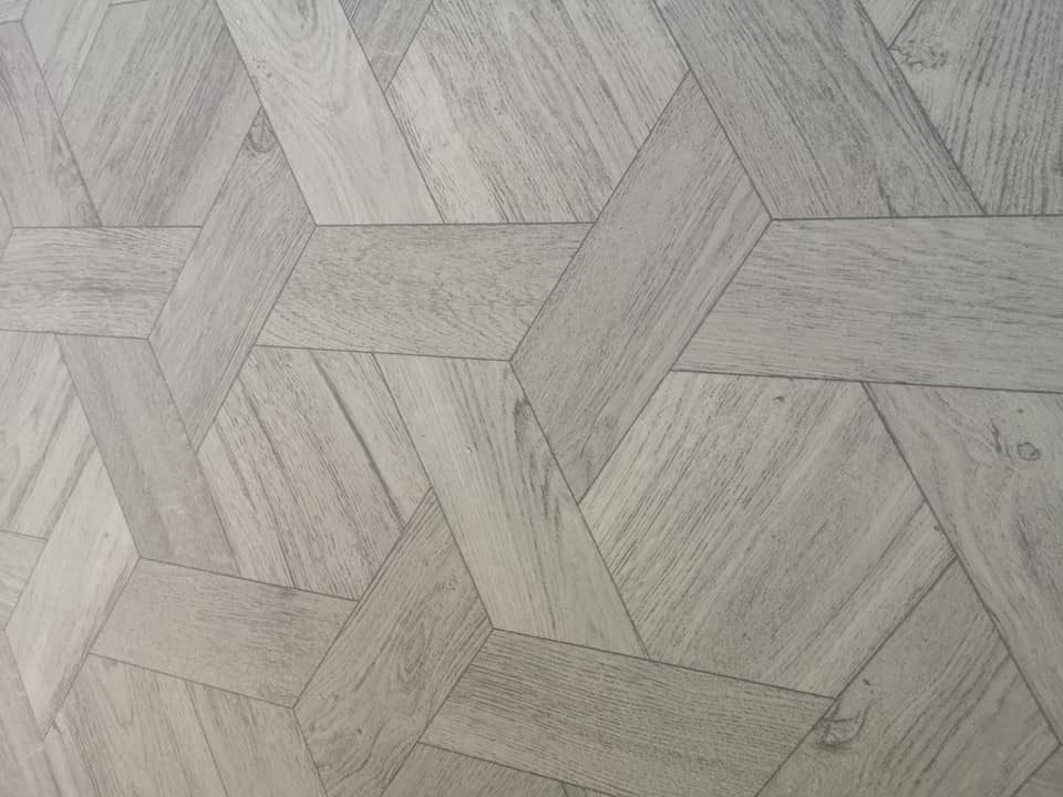 Close-up of grey wood-effect vinyl in a woven hexagon pattern
